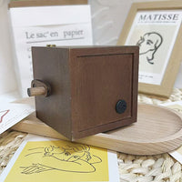 Light-emitting hand-cranked page-turning photo machine