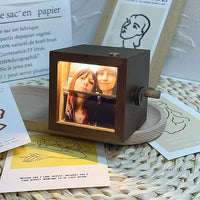 Light-emitting hand-cranked page-turning photo machine